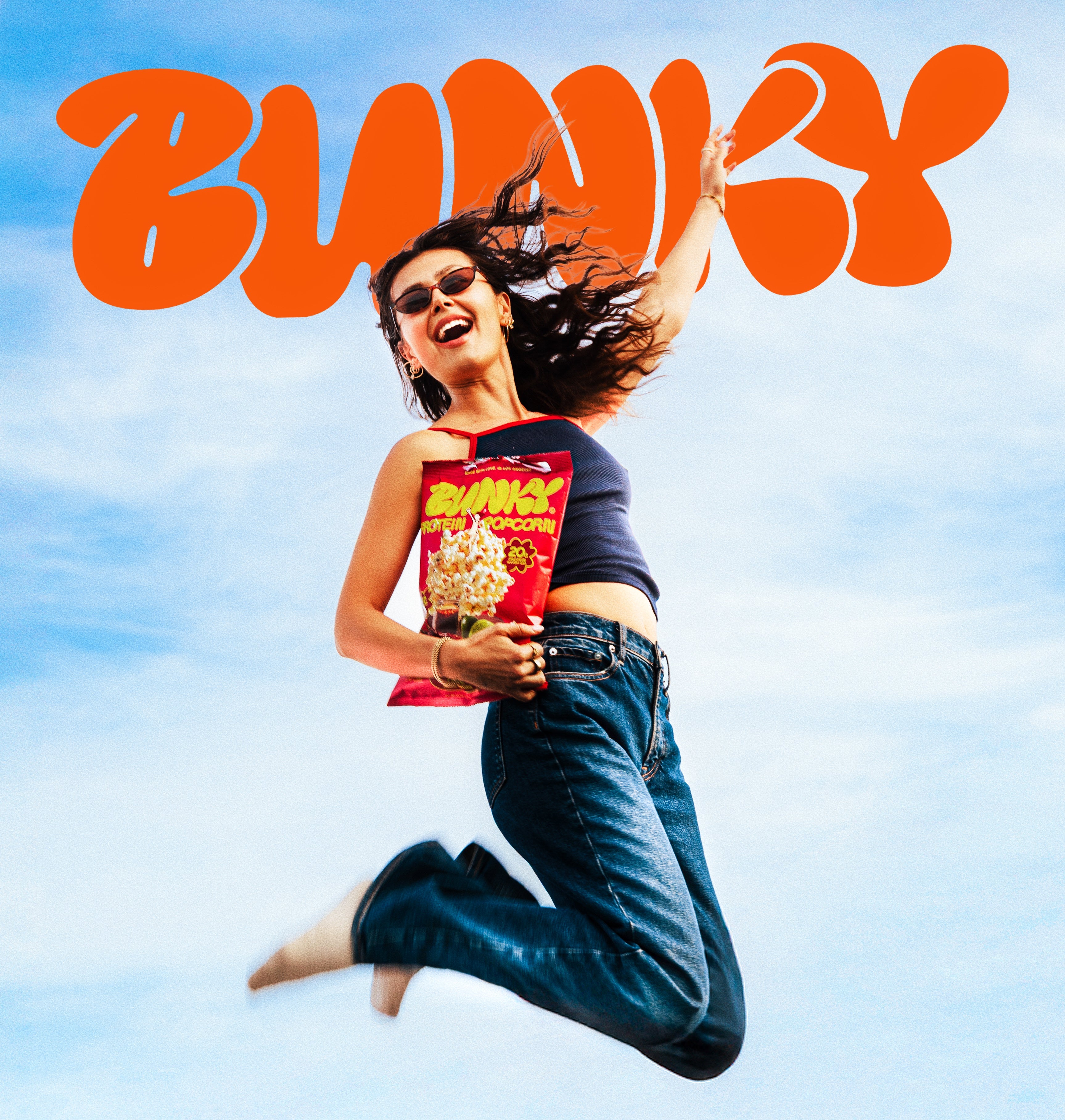 Person snacking on BUNKY hand-popped protein popcorn